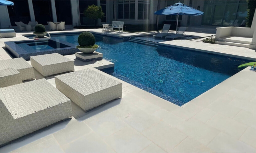 Bright limestone pool deck after cleaning and sealing